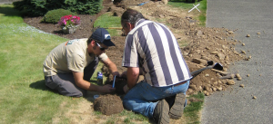 two Alexandria irrigation repair specialists replace a cracked PVC pipe